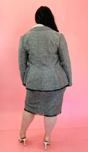 Load image into Gallery viewer, Full-body back view of a size 18 Lela Rose gray tweed, textured blazer and skirt 2-piece suit set with black unfinished fringe hem styled with an off-white button-up top and white heels on a size 14/16 model.
