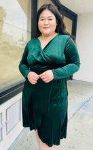 Load image into Gallery viewer, Additional front view of a size 16 Bloomchic green velvet midi dress with tulip hem and long sleeves on a size 14/16 model.
