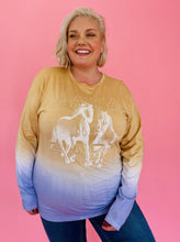 Load image into Gallery viewer, Front view of a size 3 Baja East pastel orange, white, and purple tie-dye long sleeve graphic tee with horses and &quot;Baja East&quot; printed across the front styled with medium wash jeans on a size 18 model.
