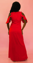 Load image into Gallery viewer, Full-body back view of a size 12 Monique Lhuillier for 11 HONORÉ vibrant red ruffled maxi with asymmetrical tulip hem, cold-shoulders, and keyhole bust detail styled with tan pumps on a size 10/12 model.
