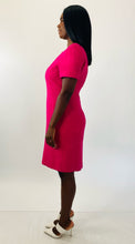 Load image into Gallery viewer, Full-body side view of a size 16 Kasper vintage hot pink short sleeve shift dress with embroidered floral details and white strappy sandals on a size 12 model.

