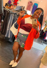 Load image into Gallery viewer, Full-body front view of a size 16 Eloquii white tee with connected maroon wrap tank detail styled under an orange blazer, with black and white striped shorts, and white slides on a size 14/16 model.
