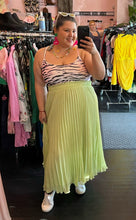 Load image into Gallery viewer, Additional full-body front view of a size 2X Forever 21 pink, black, and white tiger stripe cropped tank styled with a lime green pleated skirt and white tennis shoes on a size 16 model.
