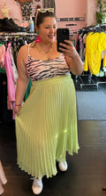 Load image into Gallery viewer, Full-body front view of a size 2X Forever 21 pink, black, and white tiger stripe cropped tank styled with a lime green pleated skirt and white tennis shoes on a size 16 model.
