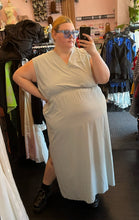 Load image into Gallery viewer, Full-body front view of a size 3X Athleta pastel mint green tank athletic dress styled with blue sunglasses on a size 22/24 model.

