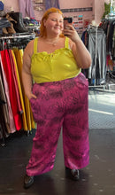 Load image into Gallery viewer, Full-body front view of a size XL Free Assembly chartreuse ribbed, textured tank with ruffled bust and tie bust detail styled with gold jewelry, pink and black mixed animal print pants and black boots on a size 22/24 model.

