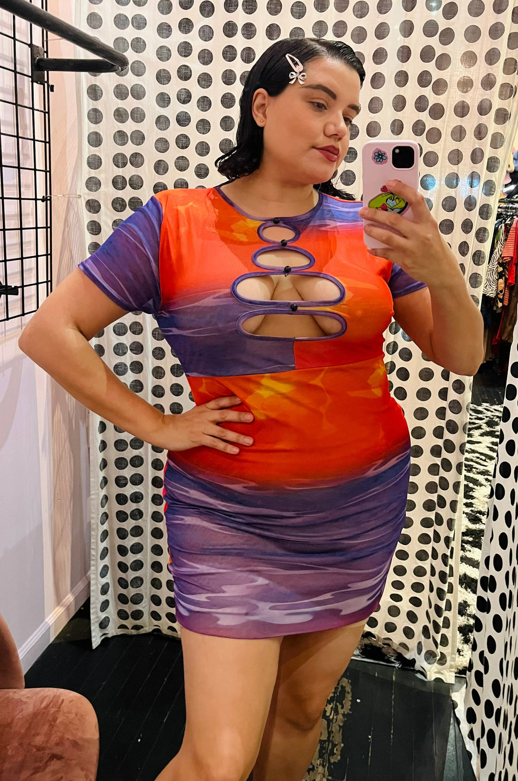 Front view of a size 14 Pretty Little Thing pink, yellow, orange, and puple water pattern keyhole bust mini dress on a size 14/16 model.