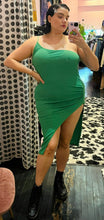 Load image into Gallery viewer, Full-body front view of a size 14 Pretty Little Thing kelly green asymmetrical high, high slit sexy midi dress styled with black combat boots on a size 14/16 model.
