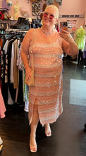 Load image into Gallery viewer, Additional full-body front view of a size 22 (fits like 18) Eloquii cream and peach vertical striped paillette maxi dress with slit styled with a tan purse and sunglasses on a size 16/18 model.
