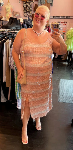 Full-body front view of a size 22 (fits like 18) Eloquii cream and peach vertical striped paillette maxi dress with slit styled with a tan purse and sunglasses on a size 16/18 model.