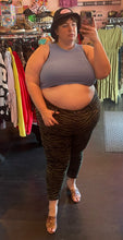 Load image into Gallery viewer, Full-body front view of a size 26P Lane Bryant olive green and black zebra stripe pants with zipper pocket details styled with a dusty blue crop top and black bucket hat on a size 24 model.
