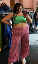 Load image into Gallery viewer, Full-body front view of a size 18 ASOS kelly green crop top with gathered straps styled with pink and maroon gingham plaid trousers and white crocs on a size 18/20 model.

