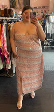 Load image into Gallery viewer, Additional full-body front view of a size 20 (fits like 16) Eloquii cream and peach vertical striped paillette maxi dress with slit styled with a tan mules and sunglasses on a size 14/16 model.
