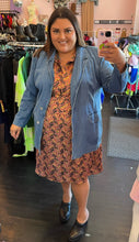 Load image into Gallery viewer, Additional full-body front view of a size 22W Eva Franco pink, maroon, orange, and green geometric print collared midi dress styled with a denim blazer and black mules on a size 18/20 model.
