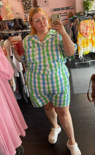 Load image into Gallery viewer, Additional full-body front view of a size 6X Big Bud Press green and blue checkered plaid short sleeve romper styled with white Crocs on a size 22/24 model.
