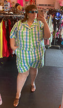 Load image into Gallery viewer, Additional full-body front view of a size 6X Big Bud Press green and blue checkered plaid short sleeve romper styled with brown heels on a size 24 model.
