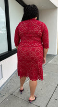 Load image into Gallery viewer, Full-body back view of a size 2 (18/20) Kiyonna bright red all-over lace bodycon dress with v-neck and scalloped edge styled with black heels on a size 18/20 model.
