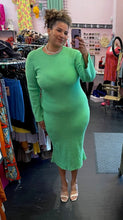 Load image into Gallery viewer, Additional full-body front view of a size L/XL (fits like 16/18) vibrant seafoam green ribbed knit sweater dress with a higher neckline and an open back styled with tan heels and a chain on a size 16/18 model. The photo is taken inside under overhead lighting.
