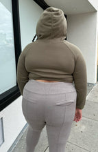 Load image into Gallery viewer, Back view of a size 2X Onuolayichu olive green cropped hoodie that reads, &quot;GIRLFRIEND&quot; styled with the hood up and gray leggings on a size 18/20 model.
