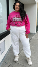 Load image into Gallery viewer, Full-body front view of a size 2X Adidas x Ivy Park white furry drawstring joggers styled with a pink long sleeve tee and white sneakers on a size 18/20 model.
