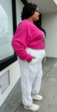 Load image into Gallery viewer, Full-body side view of a size 2X Adidas x Ivy Park white furry drawstring joggers styled with a pink long sleeve tee and white sneakers on a size 18/20 model.

