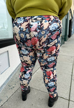 Load image into Gallery viewer, Back view of a pair of size 3X Miss Look muted multicolor floral leggings styled with a chartreuse crewneck and black boots on a size 22/24 model.
