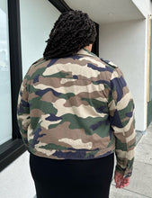 Load image into Gallery viewer, Back view of a size 2X Forever 21 green camo denim jacket with snap closure buttons styled open over a black dress on a size 18/20 model.
