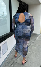 Load image into Gallery viewer, Full-body back view of size 16 Pretty Little Thing denim patchwork pattern mesh bodycon maxi dress with cold shoulders and sheer sleeves styled with black heels on a size 18/20 model.
