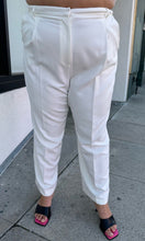 Load image into Gallery viewer, Front view of a pair of size 22 (fits like 18/20) Sally Lapointe for 11 Honoré white pleated tapered trousers on a size 18/20 model.
