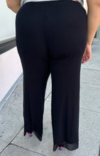 Load image into Gallery viewer, Back view of a pair of size XXL Fuzzi via 11 Honoré black trousers with button-studded pockets styled with black heels on a size 18/20 model.
