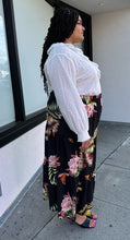 Load image into Gallery viewer, Full-body side view of a size 4X SHEIN black tiered maxi skirt with pink, yellow, and green tropical floral pattern maxi skirt styled with a white blouse and black heels on a size 18/20 model.
