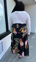 Load image into Gallery viewer, Full-body back view of a size 4X SHEIN black tiered maxi skirt with pink, yellow, and green tropical floral pattern maxi skirt styled with a white blouse and black heels on a size 18/20 model.
