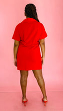 Load image into Gallery viewer, Full-body back view of a size L Everlane bright red 100% orangic cotton shortsleeve mini dress with collar detail styled with red heels on a size 14 model.
