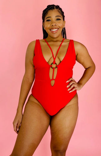 Front view of a size XL Cupshe vibrant red strappy one piece swimsuit with a tortoiseshell ring detail on a size 14 model.