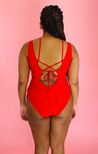 Load image into Gallery viewer, Back view of a size XL Cupshe vibrant red strappy one piece swimsuit with a tortoiseshell ring detail on a size 14 model.
