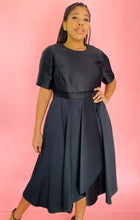 Load image into Gallery viewer, Closer front view of a size 14 Jason Wu for 11HONORÉ black a-line midi dress with a subtle high-low draping on a size 14 model.
