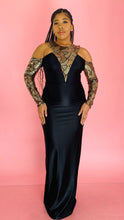 Load image into Gallery viewer, Full-body front view of a size 14 Melissa Mercedes black satin-y gown with gold, yellow, and silver sequin and beaded details on the neck and arms on a size 14 model.
