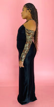 Load image into Gallery viewer, Full-body side view of a size 14 Melissa Mercedes black satin-y gown with gold, yellow, and silver sequin and beaded details on the neck and arms on a size 14 model.
