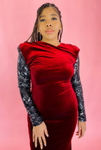 Load image into Gallery viewer, Closer view of a the high-neck, shoulder pads, and black and silver sequin sleeves on this size 12/14 deep red velvet high-neck floor-length gown with black and silver sequin sleeves and back, shoulder pad details, and a train on a size 14 model.
