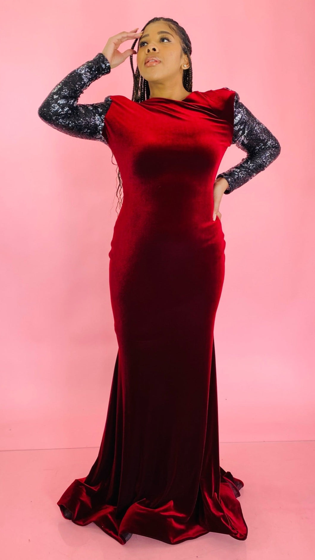 Full-body front view of a size 12/14 deep red velvet high-neck floor-length gown with black and silver sequin sleeves and back, shoulder pad details, and a train on a size 14 model.