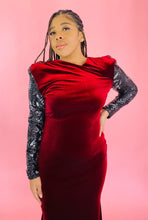 Load image into Gallery viewer, Additional closer view of a the high-neck, shoulder pads, and black and silver sequin sleeves on this size 12/14 deep red velvet high-neck floor-length gown with black and silver sequin sleeves and back, shoulder pad details, and a train on a size 14 model.
