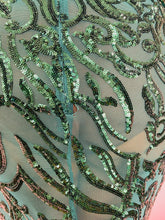 Load image into Gallery viewer, A photo depicting a small, repairable hole at a side seam on this size 12/14 Melissa Mercedes emerald green mesh, bead, and sequin gown.
