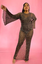 Load image into Gallery viewer, Additional full-body front view showing off the wide bell sleeves and the sheer fabric of a size 12/14 Melissa Mercedes sheer brown floor-length gown with gold sequin all-over pattern, wide bell sleeves, and back slit on a size 14 model.
