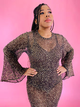 Load image into Gallery viewer, Closer view of the bodice and bell sleeves of a size 12/14 Melissa Mercedes sheer brown floor-length gown with gold sequin all-over pattern, wide bell sleeves, and back slit on a size 14 model.
