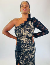 Load image into Gallery viewer, Closer view of the bodice of this size 16 Monique Lhuillier for 11Honoré one-shoulder cream gown with sheer black lace overlay and high side slit on a size 12 model.
