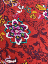 Load image into Gallery viewer, Close up view of the mixed floral pattern on a size 1/2X deep red, white, teal, yellow, and purple multicolor floral baby doll blouse with long sleeves, a drawstring neckline, and side slits.

