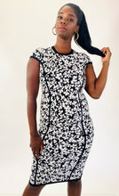 Load image into Gallery viewer, Front view of this size M Michael Kors black and white textured floral sheath midi dress with cap sleeves on a size 12 model.
