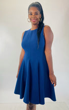 Load image into Gallery viewer, Front view of a size 16 Michael Kors navy blue high-neck a-line dress with circle skirt on a size 12 model.
