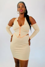 Load image into Gallery viewer, Front view of a size 1X Fashion Nova light tan and orange exposed seam 2-piece with zip-up extreme cold shoulder halter top and bodycon mini skirt on a size 12 model.
