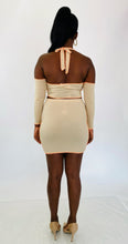 Load image into Gallery viewer, Full-body back view of a size 1X Fashion Nova light tan and orange exposed seam 2-piece with zip-up extreme cold shoulder halter top and bodycon mini skirt styled with tan patent leather pumps on a size 12 model.
